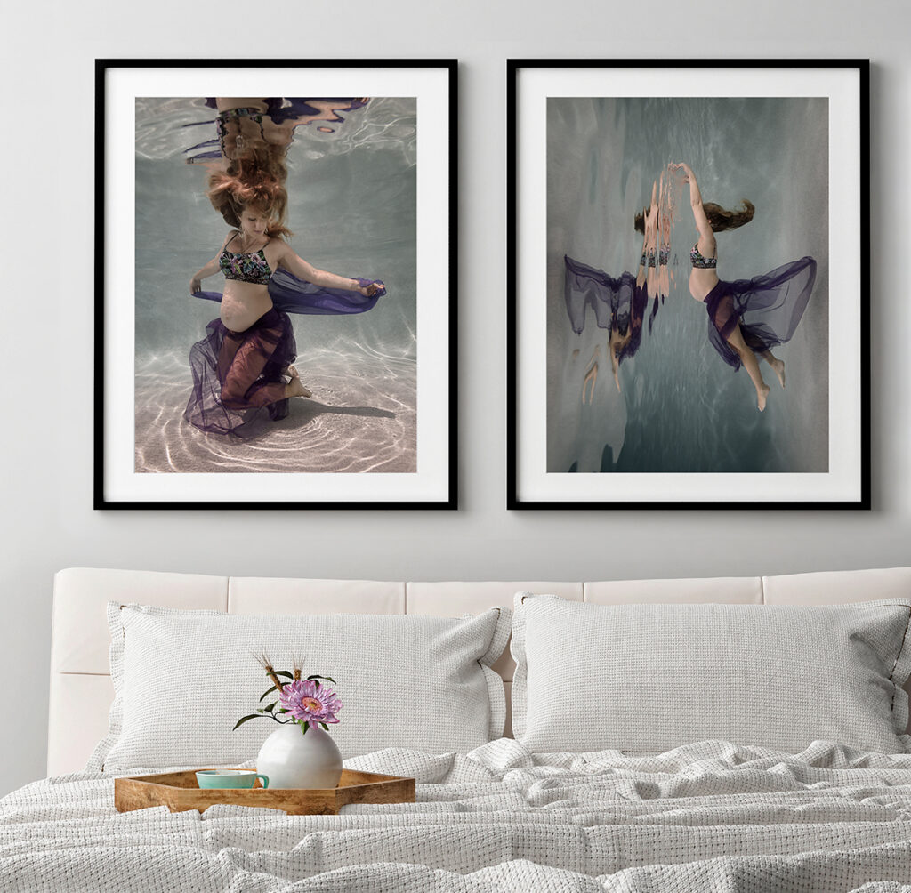 Pair of artworks of pregnant woman underwater, displayed over a bed with white bedding