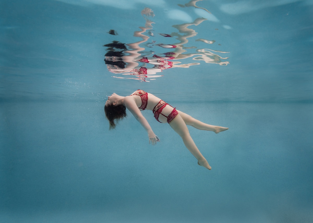 woman in red lingerie floating underwater