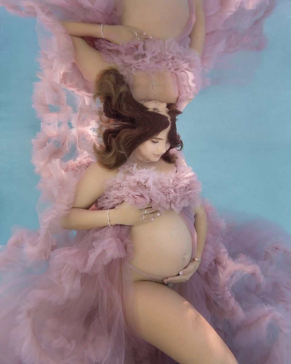 unique dreamy pink dress underwater maternity portrait